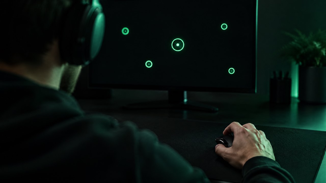A player practising aim on glowing green targets at night